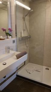 a bathroom with a shower and a sink at Landhotel Böld Oberammergau in Oberammergau