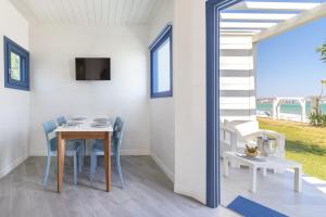 a dining room with a table and chairs at Arìa Residenze d'aMare in Crotone