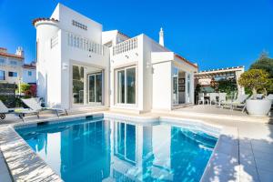 a large white house with a swimming pool at WHome | Prime Hideaway Luxury Villa in Quarteira