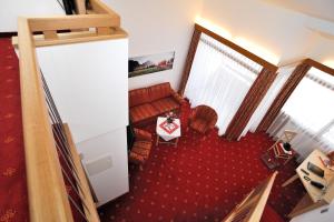 an overhead view of a living room with a red couch at Landhotel Böld Oberammergau in Oberammergau