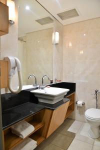 a bathroom with a sink and a toilet at Cresta Jameson Hotel in Harare