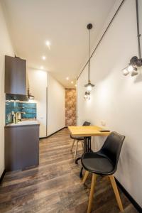 a kitchen and dining room with a table and chairs at DayFlat Apartments on Mykhailivs'ka in Kyiv