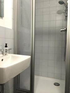 a bathroom with a sink and a shower at Apartment&Rooms near Brandenburg Gate in Berlin +40 photos