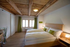 a bedroom with a large bed and a window at La Maison Salvagny in Murten