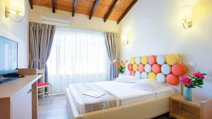 a bedroom with a bed with a colorful headboard at Michelangelo Resort in Kassiopi