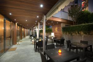 a restaurant with tables and chairs on a patio at Residence Calissano in Alba