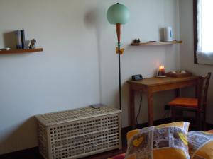 ein Zimmer mit einer Lampe und einem Tisch mit einem Stuhl in der Unterkunft Il Farfasole in Vigonovo