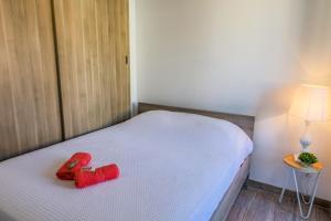 a red stuffed animal is sitting on a bed at MASSENET PIETONNE AP4196 by Riviera Holiday Homes in Nice