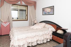 a bedroom with a bed and a window at MARIVENT-A, 10-30 in Cullera +23 photos