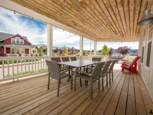 a wooden deck with a table and chairs on it at Rendezvous #20 in Chelan