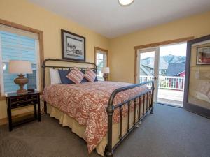 a bedroom with a bed and a balcony at Rendezvous #20 in Chelan +32 photos