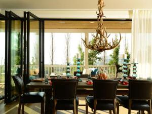 a dining room with a table and chairs and a chandelier at Arroyo #60 in Chelan