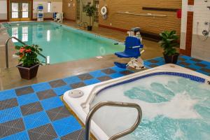 a swimming pool with a jacuzzi tub in a building at Fort Marcy Suites in Santa Fe