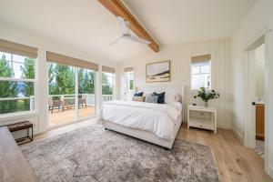 a bedroom with a white bed and a large window at Best.Day.Ever. #58 in Chelan +45 photos
