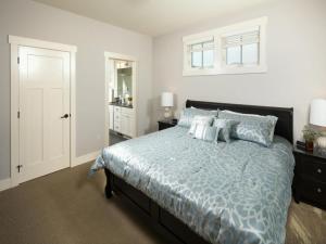 a bedroom with a bed with a blue comforter and pillows at A Perfect Day #25 in Chelan +29 photos