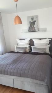 a bedroom with a gray bed with white pillows at Ferienwohnung Sonnenschein in Goslar