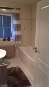 a bathroom with a tub and a shower and a sink at Ferienwohnung Sonnenschein in Goslar +14 photos
