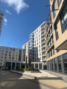 a large building with a statue in front of it at Woking Town Centre - Parking Included by Deilamy Homes in Woking
