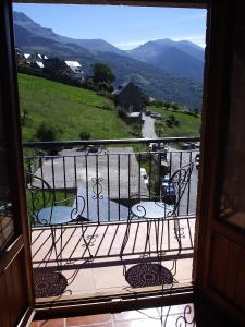 a view of a balcony with a table and chairs at Casa Feixas in Gistaín