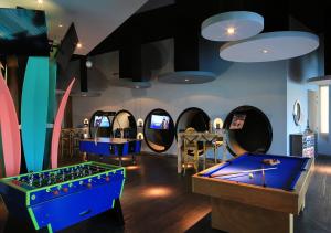 a room with two pool tables and arcade games at Grand Velas Riviera Nayarit in Nuevo Vallarta