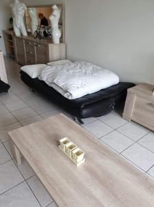 a room with a bed and a coffee table with a table sidx sidx at Residentie GALAXY in Middelkerke