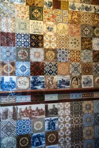 a wall filled with lots of different types of tiles at Bed & Breakfast The 9 Streets in Amsterdam