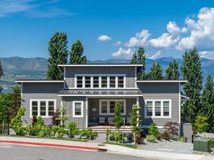 a house on a hill with mountains in the background at Hello Sunshine #51 in Chelan