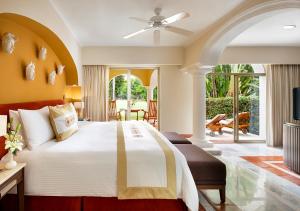 a bedroom with a large bed and a patio at Casa Velas Adults Only All Inclusive in Puerto Vallarta +35 photos