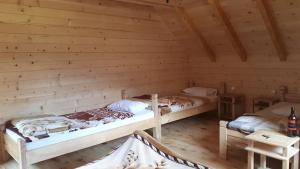 a room with two beds in a log cabin at Komovi Eko Katun Martinovica 1750 in Kolašin