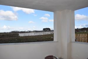a window in a white room with a view of a field at Hotel Restaurante Racha in Endrinal +4 photos