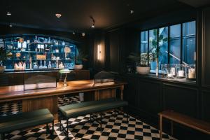 a bar with a checkered floor at Getaway Gent in Ghent