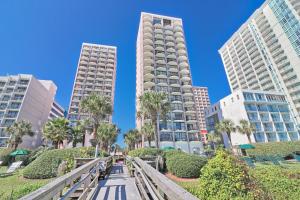 a walkway in a city with tall buildings at Suites at the Beach in Myrtle Beach
