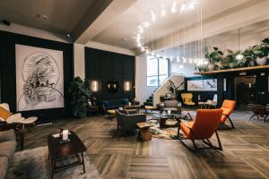 a lobby with couches and chairs and a lobby with at Getaway Gent in Ghent