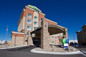 a front view of a hotel with a building at Holiday Inn Express and Suites Denver East Peoria Street, an IHG Hotel in Denver