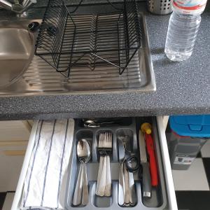 a drawer in a sink with utensils in it at Apartment Krefeld City in Krefeld