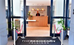 a entrance to theresienbey wellness lobby with plants at The Residency Jellicoe in Johannesburg