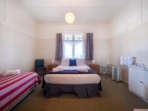 a bedroom with two beds and a window at Hotel Lake Brunner in Moana