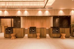 a lobby with a row ofools in a building at Hotel Keihan Nagoya in Nagoya