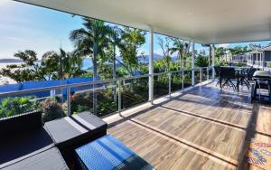 a house with a balcony with a view of the ocean at Blue Water Views on Hamilton Island by HIHA in Hamilton Island