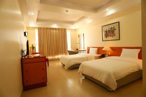 מיטה או מיטות בחדר ב-Semec Hotel Nghi Son