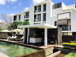 a building with a swimming pool in front of it at Sea view Belle Haven Penthouse in Mont Choisy