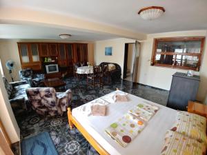 a living room with a bed and a dining room at Tony Guest House in Sozopol