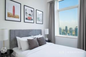 A bed or beds in a room at LUX - The Dubai Marina Sea View Suite