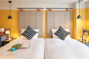 Postel nebo postele na pokoji v ubytování Hotel Resol Yokohama Sakuragicho