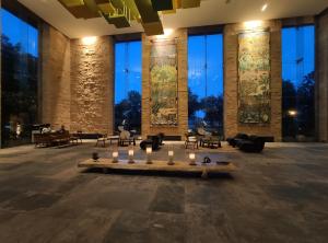 a lobby with a table with candles in it at The Gateway Resort Damdama Lake in Gurgaon
