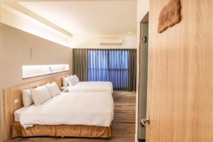 Postel nebo postele na pokoji v ubytování Traveller-Inn Zhongzheng Library