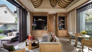 a living room with a couch and a table at Banyan Tree Yangshuo in Yangshuo