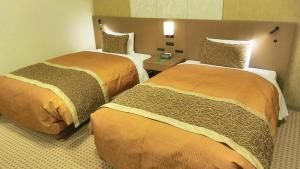 Un ou plusieurs lits dans un hébergement de l'établissement Hotel Metropolitan Nagano