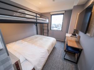 a bedroom with a bunk bed and a desk at Super Hotel Anan City Hall Smoke-Free in Anan +89 photos