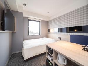 a bedroom with a bed and a flat screen tv at Super Hotel Anan City Hall Smoke-Free in Anan